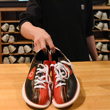Bowling shoes being handed over the counter