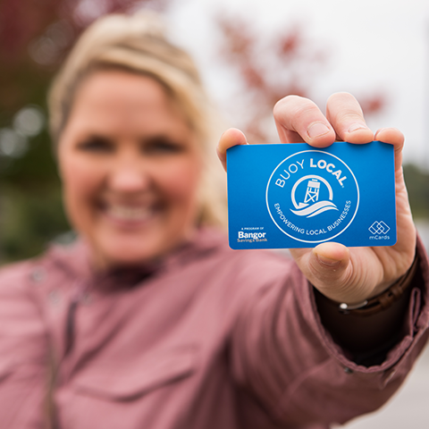 A person holding a Buoy Local Card
